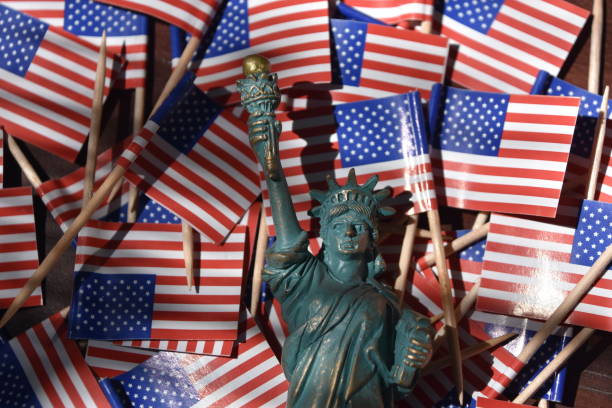 istock Statue of Liberty against the backdrop of US flags 806295842