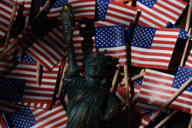 istock Statue of Liberty against the backdrop of US flags 806297956