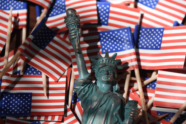 istock Statue of Liberty against the backdrop of US flags 806298412
