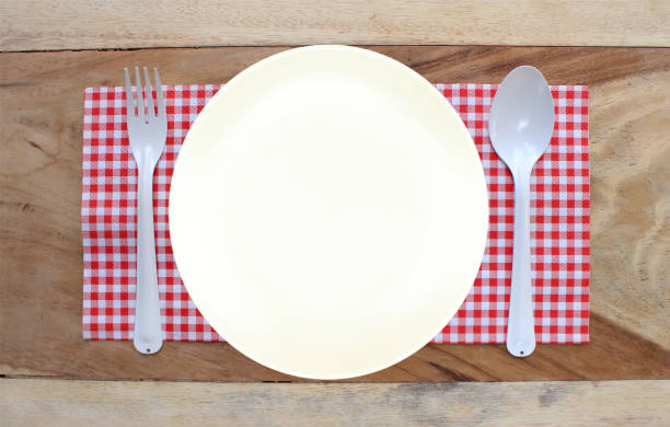 istock plate on tablecloth and spoon with fork for food serving background 806298580