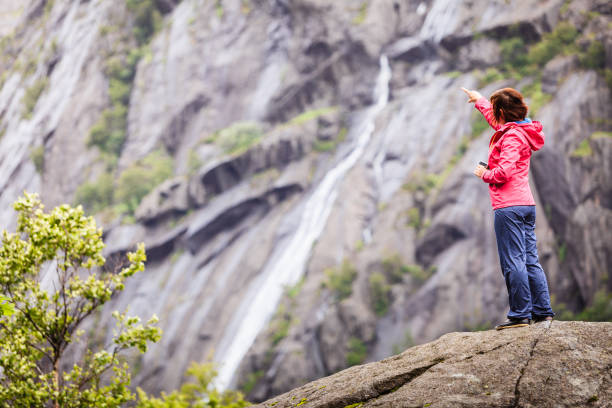 istock Woman on mountain rock enjoying beautiful view 806300850