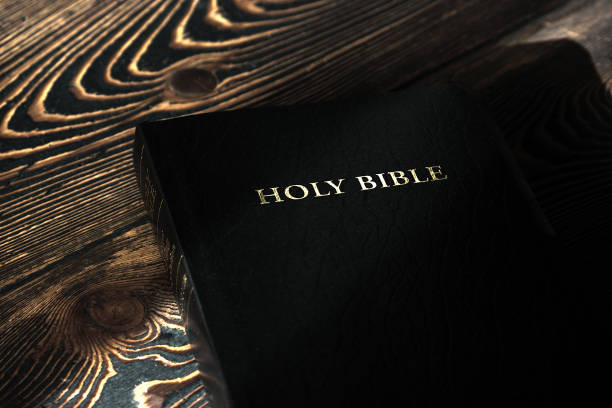 istock The Bible on the old wooden table, top view 806301172
