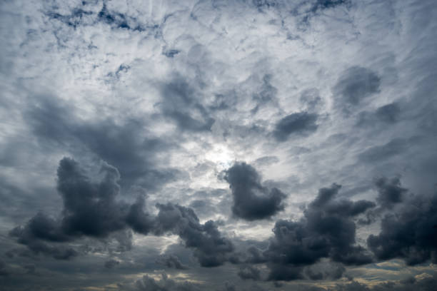 istock clouds with background,sunlight through very dark clouds background of dark storm clouds,black sky Background of dark clouds before a thunder. 806301614