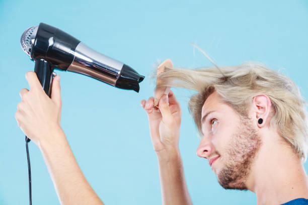 istock Trendy man with hair dryer 806301814