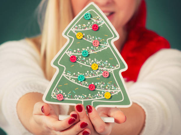 istock Woman holding decorative christmas tree 806304260