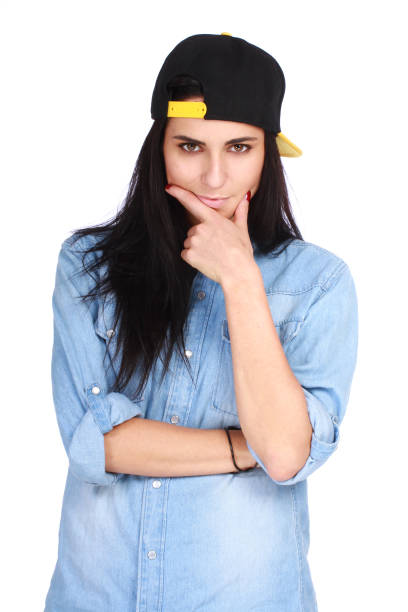 Portrait of young woman in cap posing on white stock photo