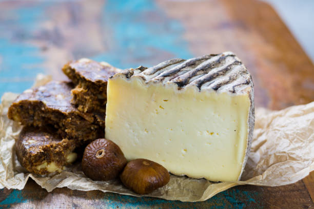 istock Ancient french cheese Tomme de Montagne and dried figs with figs bread 806310016