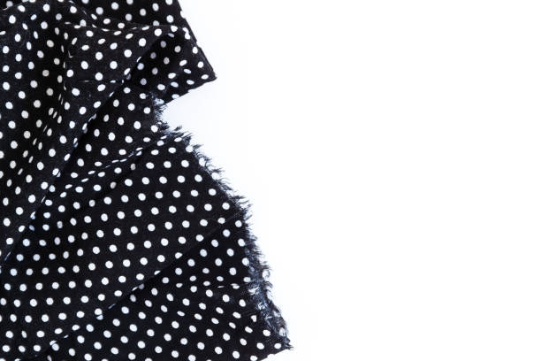 istock Piece of black fabric with a pattern of white peas, isolated on a white background 806312770