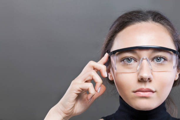 Futuristic smart glasses Young woman loking at virtual graphics in futuristic background smart glasses eyewear stock pictures, royalty-free photos & images