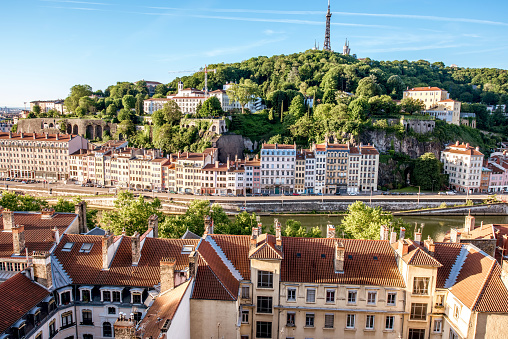 Morning aerial cityscape view with beautiful old buildings and metallic tower on the mountain in Lyon city in France