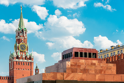 Lenin's Mausoleum - Lenin's Tomb - and famous Spasskaya Tower (left) Moscow's Red Square in summer under blue summer sky. Red Square, Moscow, Russia