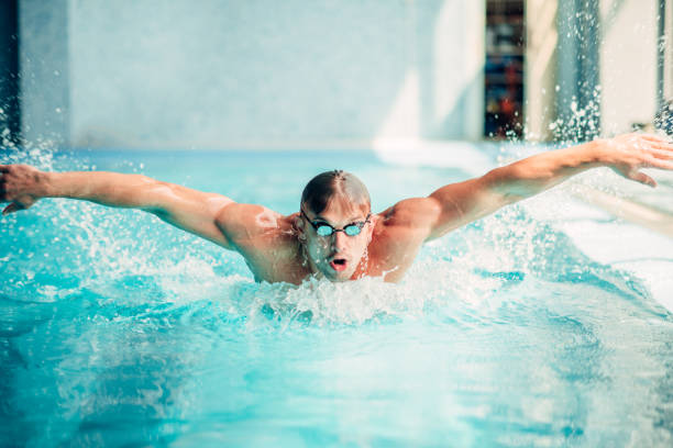 istock Athletic swimmer swims in butterfly style 806328250