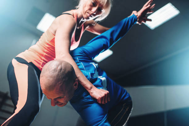 istock Male and female fighters, self-defense technique 806331062
