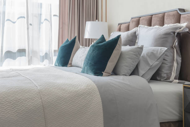 istock classic bedroom style with set of pillows and lamp on table side 806355084