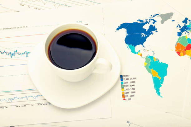 istock Coffee cup and calculator over world map and some financial documents - business concept 806367490