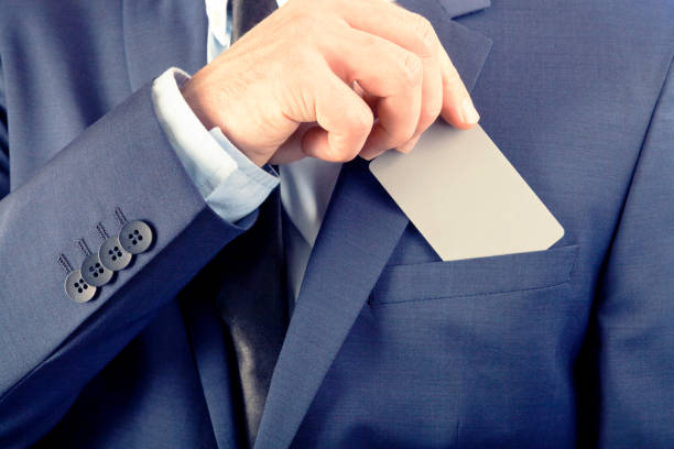 istock Businessman in suit holding blank card with YOUR TEXT OR IMAGE. Filtered image: cross processed vintage effect. 806367608