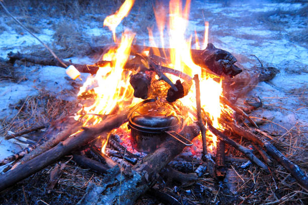 istock Pan on campfire at night in winter forest. Cooking in campaign camp fire. Travel accessories. Tourist rest. 806377776