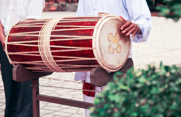 istock Vietnamese drum. The musician holds the drum and plays it 806380870