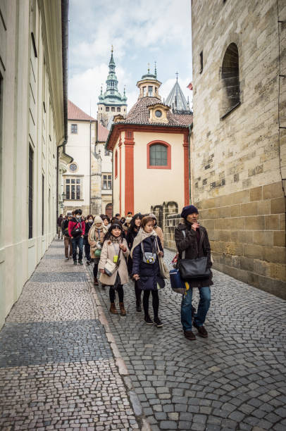 Group of Japanese tourist taking a tour with a tour guide at Prague Castle, Czech Republic