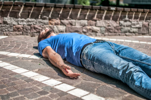 istock unconscious boy in a park 806405296