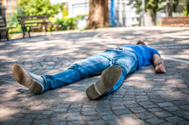 istock unconscious boy in a park 806405382