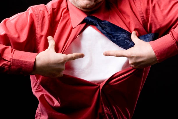 istock Casual man pointing with both hands to his white t-shirt isolated 806415300