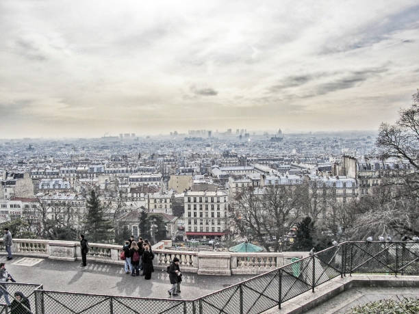 Paris, France - 2/18/2003: This view of the Paris Skyline and city view is available from the Butte Montmartre the highest point in Paris where the Basilica Sacre-Coeur is located and many visitors as well as locals visit this location to enjoy the breath taking views of his world reknown location the many men and women find this view memorable and on this February day it was breathtaking.