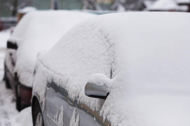 istock Heavy snowfall, passenger car covered with white snow 806439162