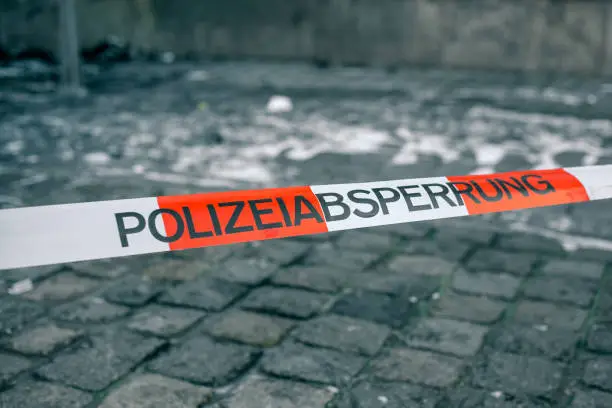 Police tape in Germany at the crime scene with the inscription in German police cordon. Crime Scene Investigation.