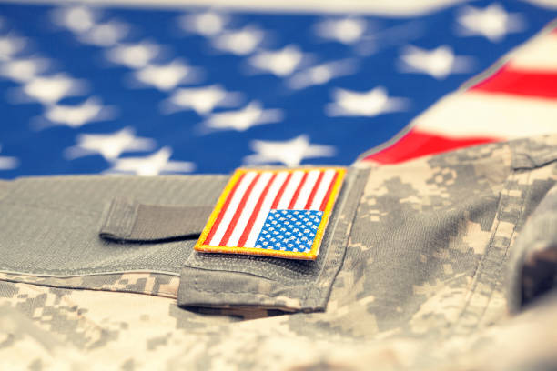 istock New USA army uniform over flag - focus on stripe. Filtered image: cross processed vintage effect. 806471438