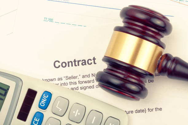 istock Wooden judge's gavel and calculator over some financial documents 806476490
