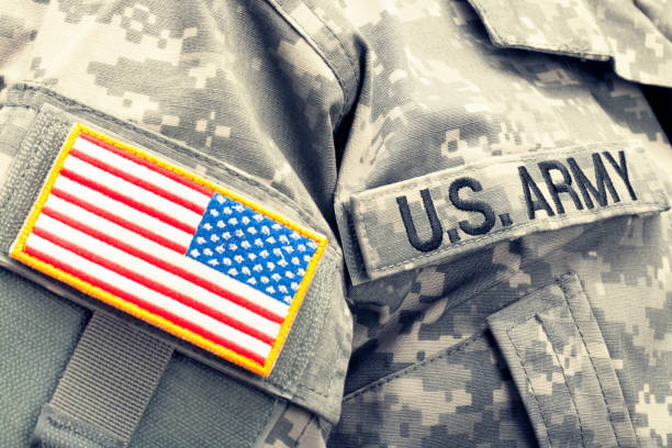 istock USA flag and U.S. Army shoulder patch on solder's uniform. Filtered image: cross processed vintage effect. 806478732