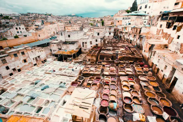 Fez cityscape from above with traditional leather tanning and dyeing tannery in the old medina of Fez - Fes, Morocco, Africa.