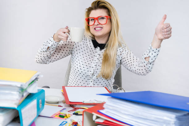 istock Happy woman at office drinking hot coffee 806501884