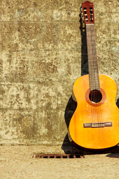 istock acoustic guitar outdoor on wall background 806501948