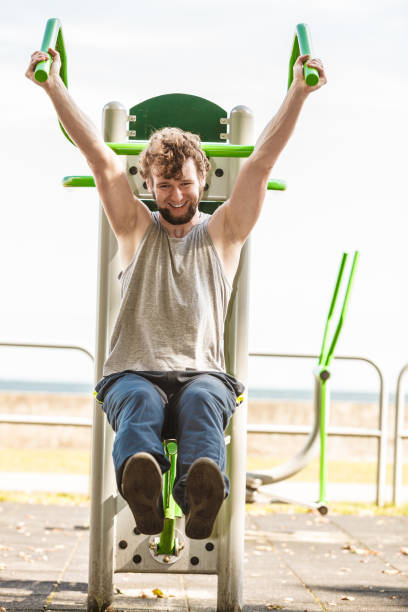 istock Active man exercising on chest press outdoor. 806502122