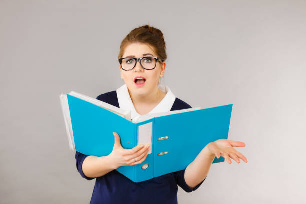 istock Shocked business woman looking at documents 806504646