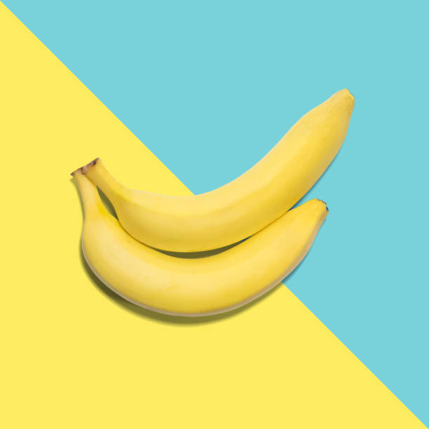 istock Banana on a blue and yellow background. Minimal concept. Pop color. 806506878