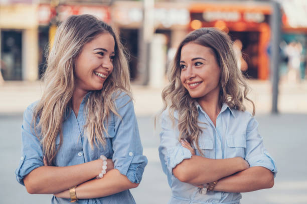 istock Sisters with arms crossed looking at each other 806511664