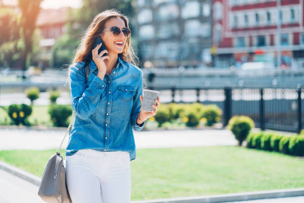 istock Beautiful young woman with mobile phone 806511670