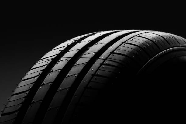 istock Car tire on black background 806523282