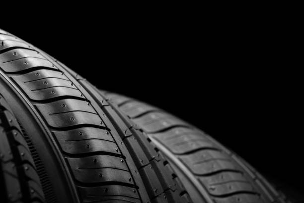istock Car tires on black background 806523334