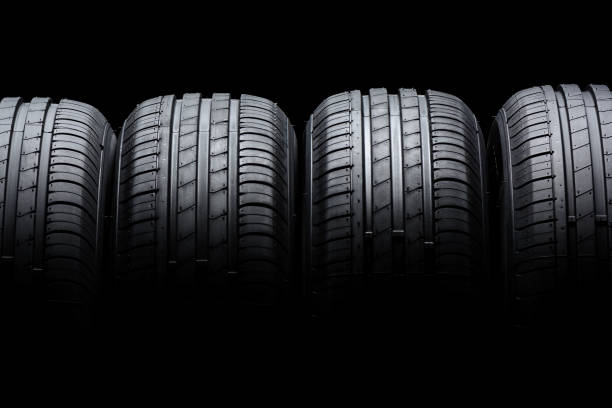 istock Car tires on black background 806523374