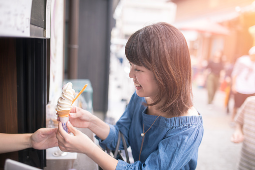 Young woman receiving ice cream