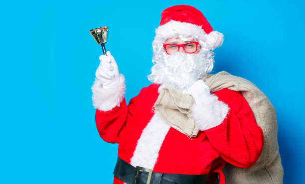 istock Funny Santa Claus have a fun with bell 806550506