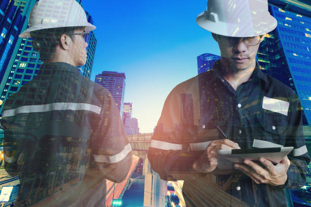 istock Double exposure of  Engineer or Architecture man in working shirt and safety helmet working with tablet in night building background , business and construction concept. 806594164