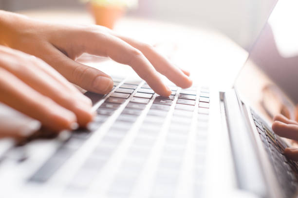 istock Hands working on the computer keyboard, pressing buttons, typing, simple close up with lens flare 806619528