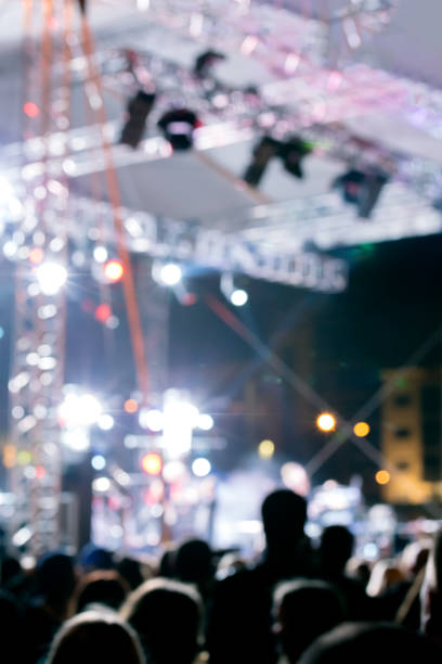 istock crowd at concert against brightly lit stage. bright concert lighting. blurred image. 806626908