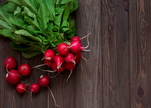 istock Bunch of radish on wooden table. Top view 806637196