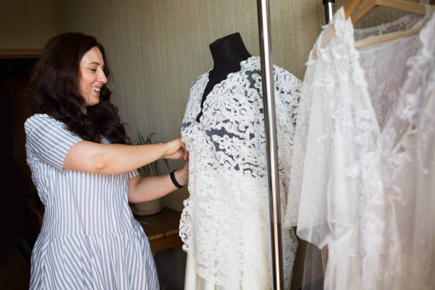 istock Dress designer making lace wedding dresses.Handmade. 806688826